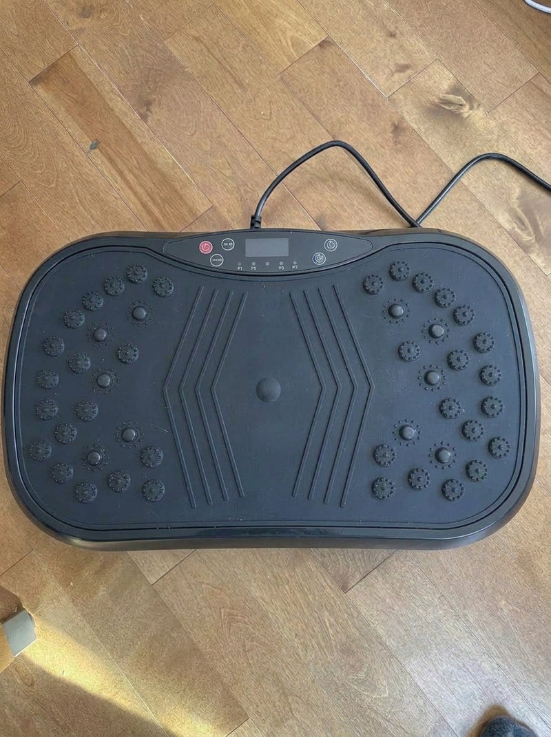 Customer photo of the vibration plate plugged in on a wooden floor