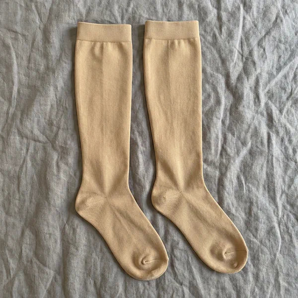 A pair of beige compression socks